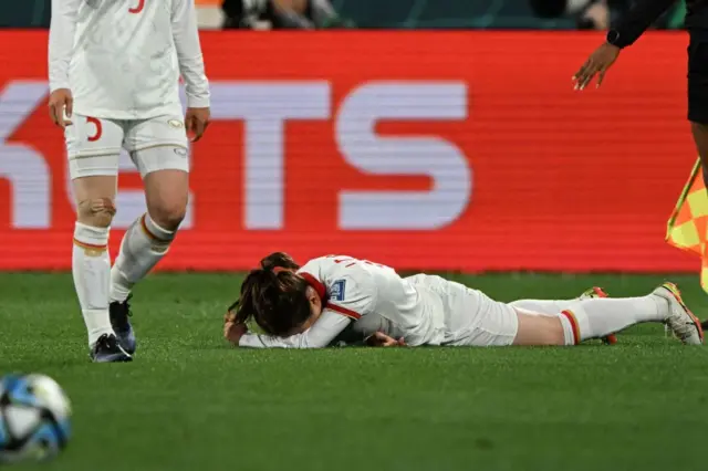 A Vietnam player lies on the floor after suffering a strong challenge.