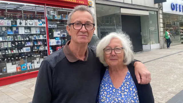 An older couple pose for the photo