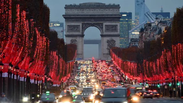 Paris's Arc de Triomphe stands in a busy road junction at the end of the Champs Elysees