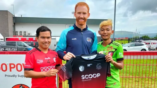 Derry GAA's Conor Glass joined in the fun with Check Vannak (left) and Chea Seyma (right)