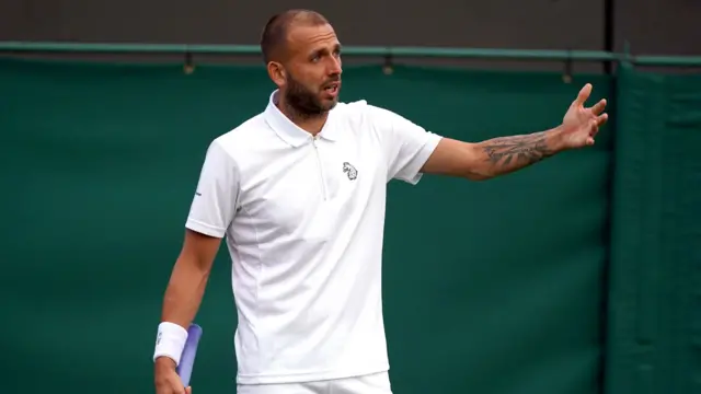 Dan Evans gestures with his arm