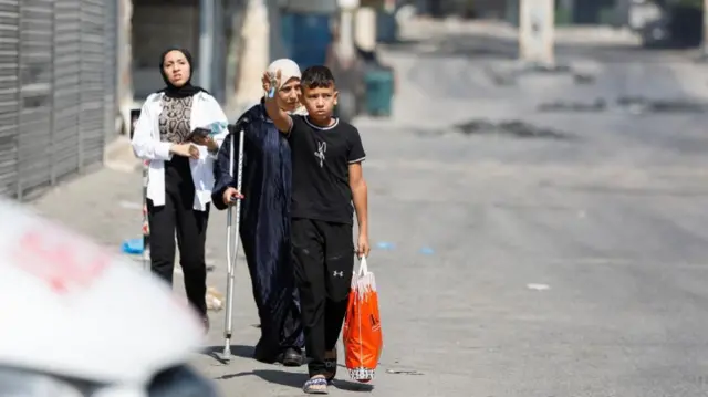 Palestinians walking during an Israeli military operation in Jenin