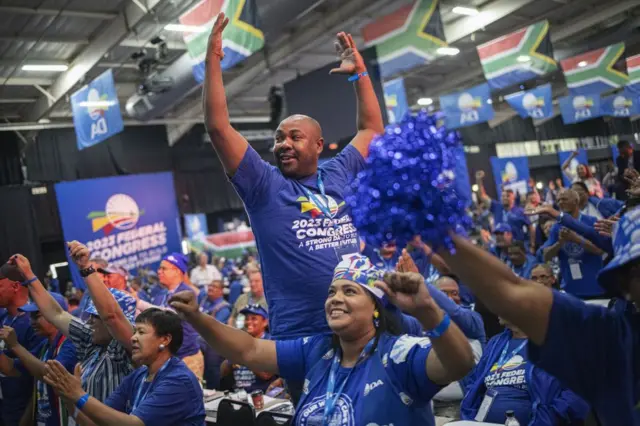 South African main opposition party Democratic Alliance (DA) members cheers and dance at the party's Federal Congress in Midrand, Johannesburg on April 2, 2023