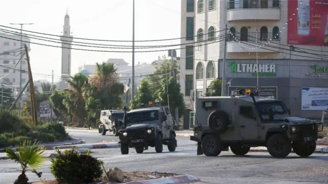 Israeli military vehicles maneuver during a raid in Jenin