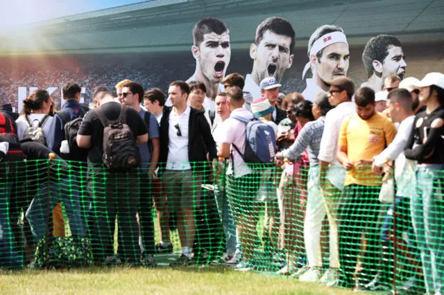 Spectators queue in the Wimbledon Park