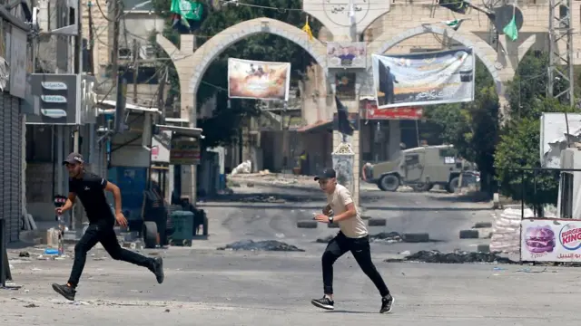 Palestinians run for cover in Jenin