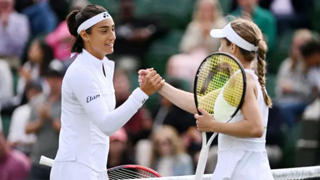 Caroline Garcia shakes hands with Katie Volynets