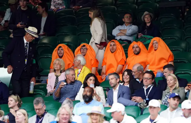 Spectators dressed as carrots