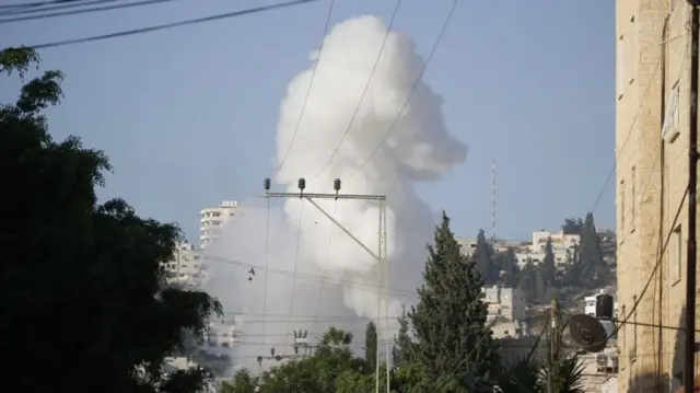 Smoke plume rising over Jenin