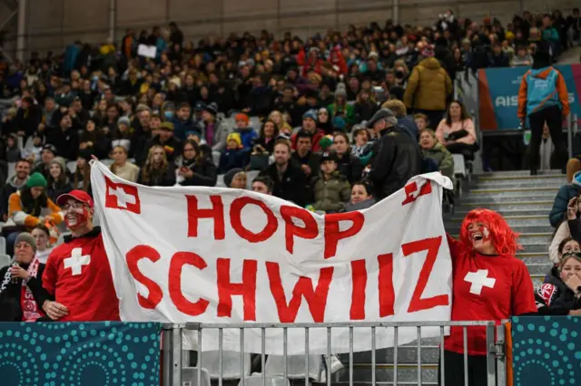 Swiss fans hold a banner in support of their team.