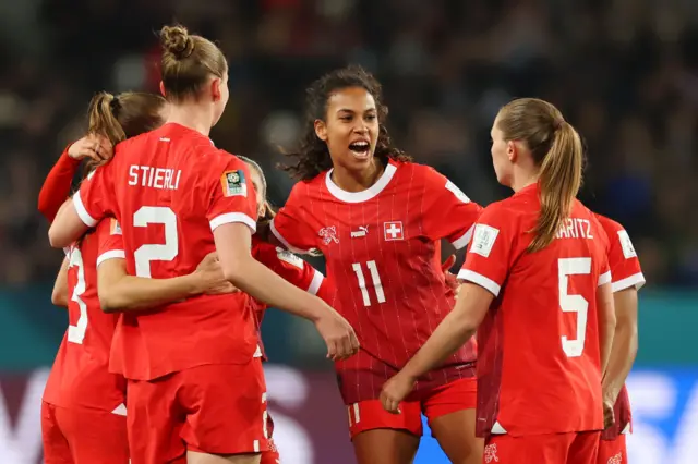 Switzerland players celebrate advancing to the next round.