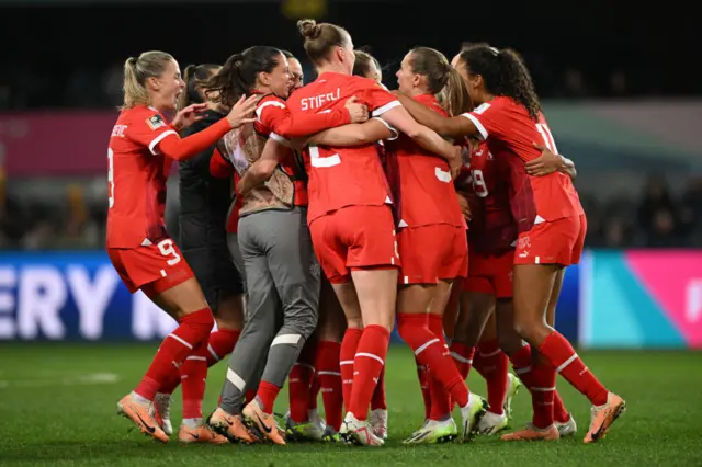 Swiss players celebrate advancing into the next round.