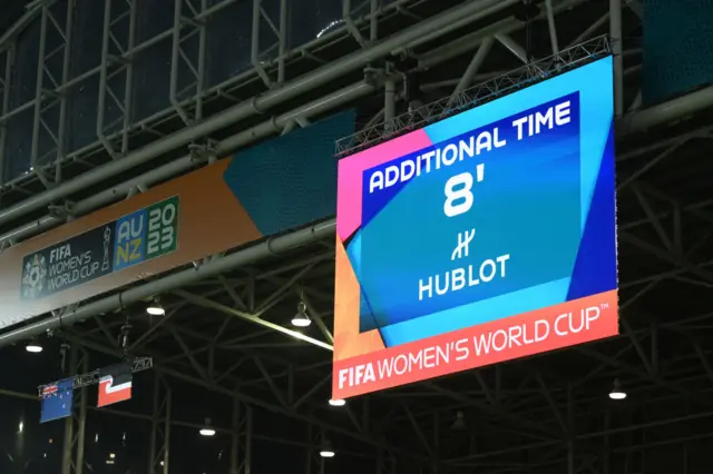 The scoreboard shows eight minutes of stoppage time.