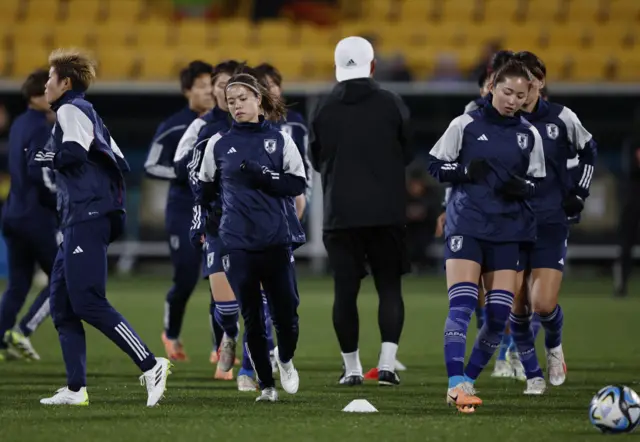 Japan players warm up ahead of their match with Spain.