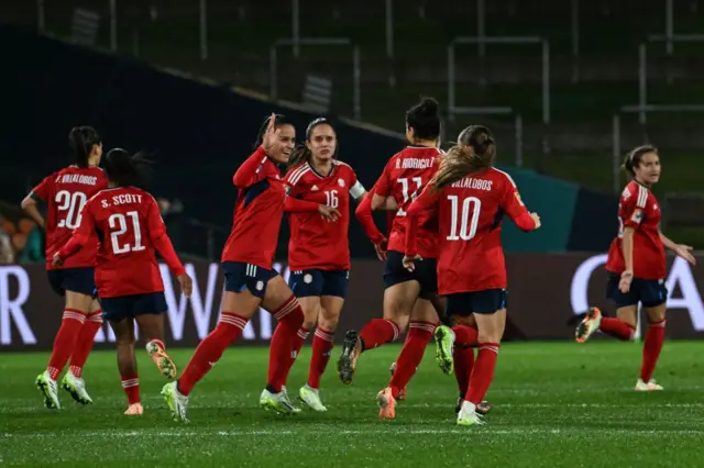 Costa Rica players run back to the halfway line to get the game back under way after scoring.