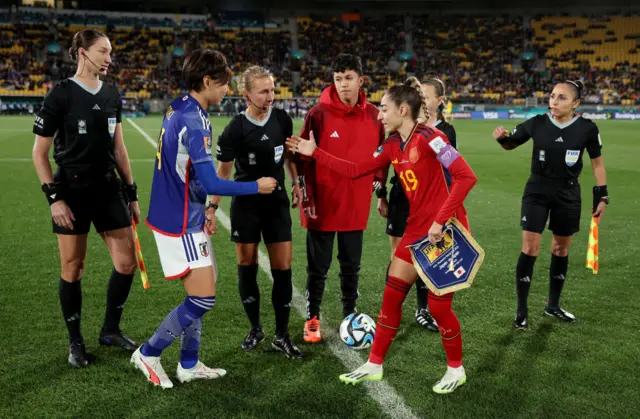 Japan and Spain captains shake hands before the coin toss.