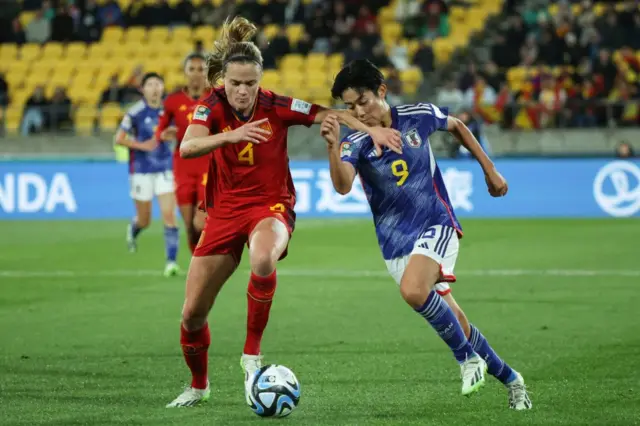 Paredes and Ueki battle for possession.