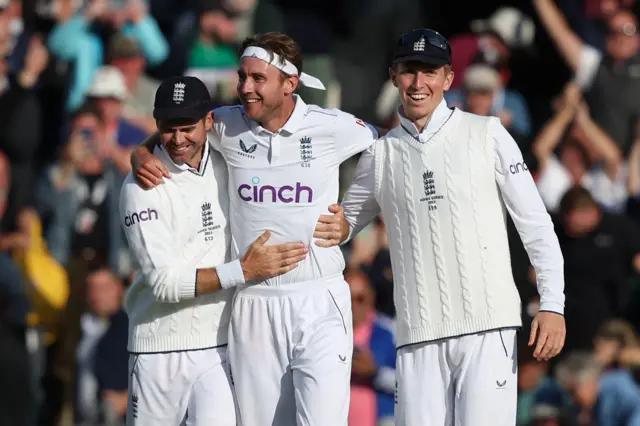 Stuart Broad celebrates with James Anderson and Zak Crawley