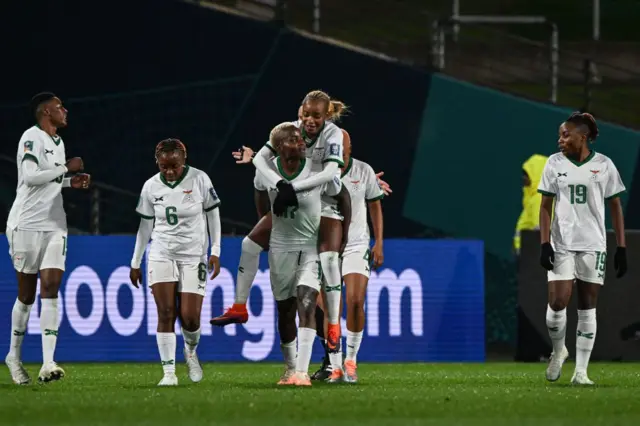 Zambia players celebrate the third goal with scorer Kudananji