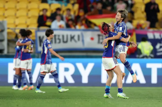 Japan players celebrate their historic win over Spain.