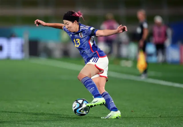 Jun Endo dribbles the ball with her left foot.