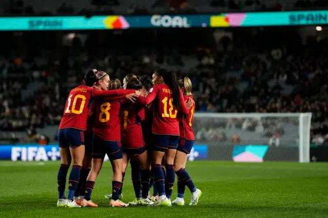 Spain players celebrate together after scoring v Zambia.