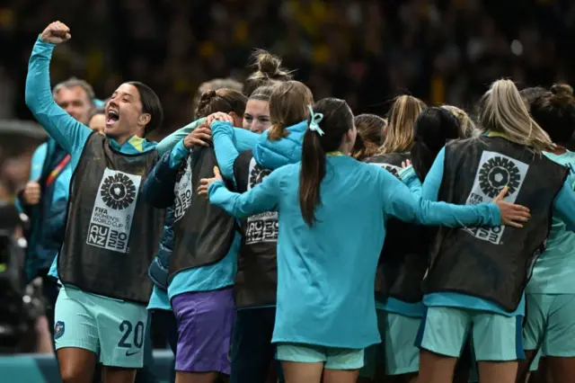 Sam Kerr celebrates with teammates after her side score again.