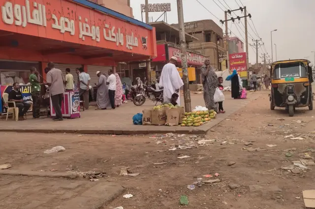 People queue for bread in front of a bakery in Omdurman on July 15, 2023.