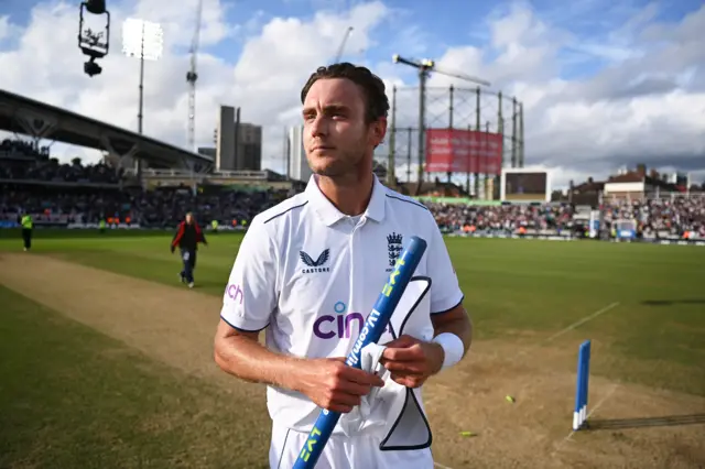 Stuart Broad walks off with a stump