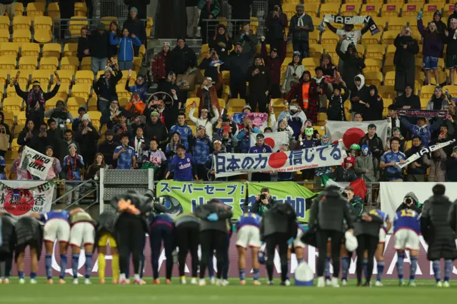 Japan players celebrate in front of their fans after their win over Spain.