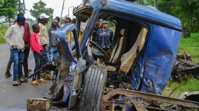 People view the wreckage of the truck that lost control killing over 50 people on Friday June 30th in Londiani Trading Center located 220km North West of Nairobi.