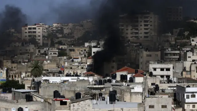 Smoke rises over Jenin during clashes with the Israeli army