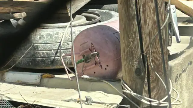 Alleged IED placed by a electricity or telephone police by a roadside