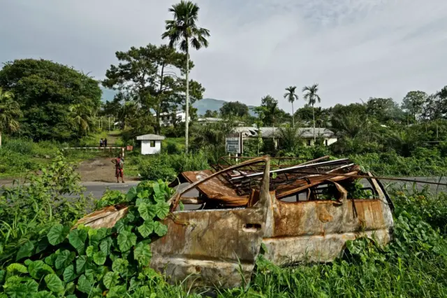 A burnt-out car at the entrance of a former government-owned banana plantation at the entrance of a former government-owned banana plantation on May 22,2019 in Buea,Cameroon.