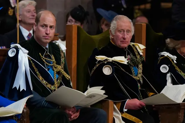 Prince William and King Charles look on during the service