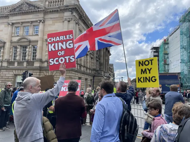 Protesters and fans of the royals are mingling on the Royal Mile