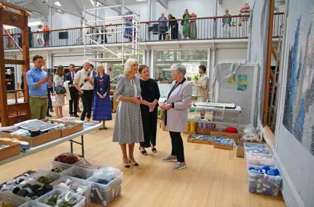 Queen Camilla visits Dovecot studios in Edinburgh to meet weavers, staff and local crafts people