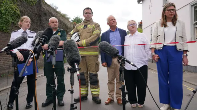 Police, ambulance and fire officials, together with headteacher Helen Low and headteacher-elect Sharon Maher and chairman of the board of governors, John Tucker at new conference