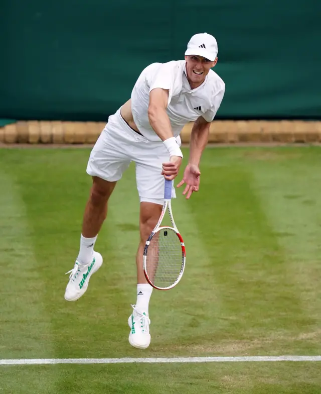 Jan Choinski after hitting a serve