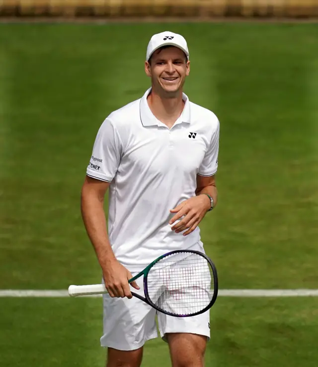 Hubert Hurkacz smiles on court 18