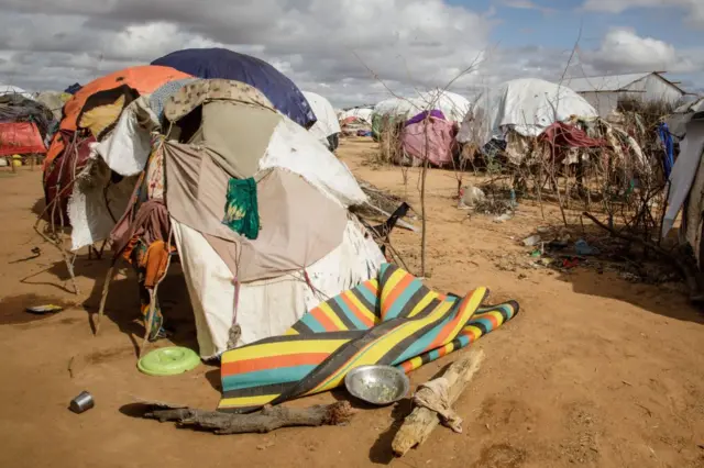 An empty plate remains next to Somali refugees' makeshift shelter in the Dadaab refugee camp, one of Africa's largest refugee camps in Kenya, on March 23, 2023.