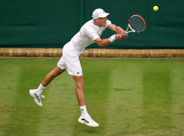 Jan Choinski stretches to return a serve