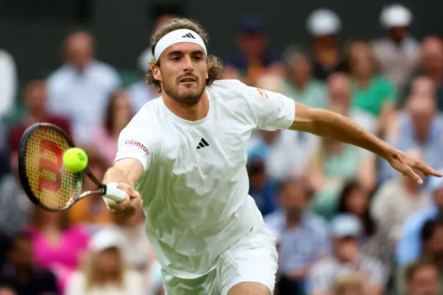 Stefanos Tsitsipas stretching for a forehand