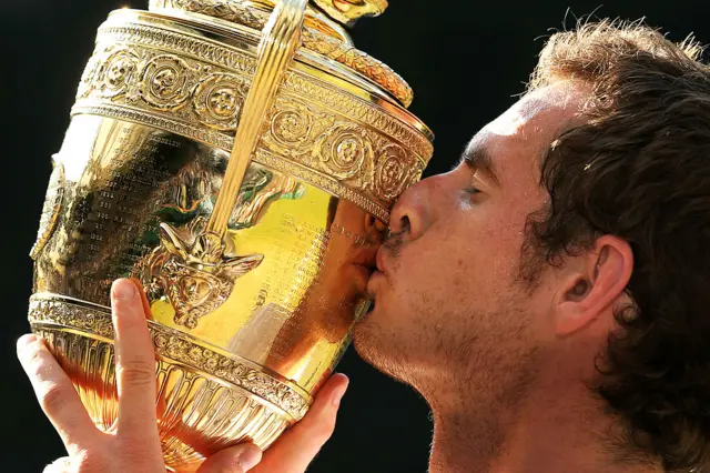 Andy Murray kisses the Wimbledon trophy