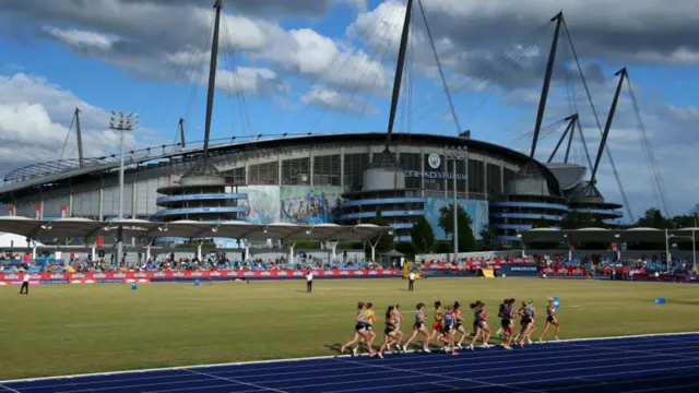 Athletes make their way around the track at Manchester Regional Arena