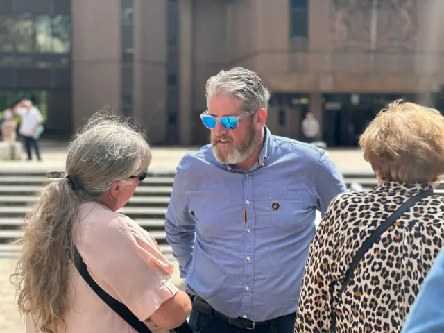 Tim Edwards speaks to others outside Liverpool Crown Court
