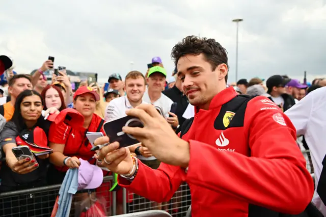 Charles Leclerc takes pictures with fans