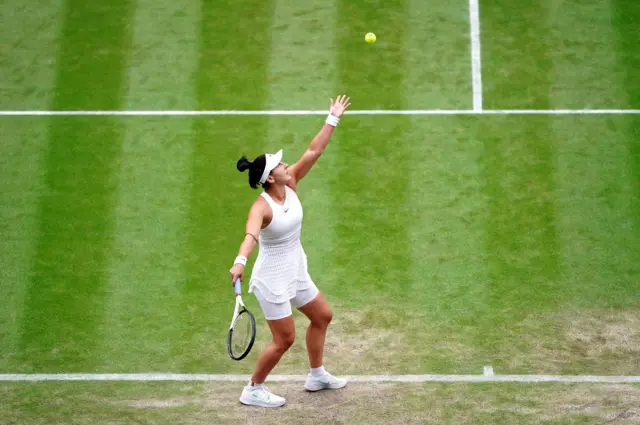 Bianca Andreescu throws the ball up to serve.