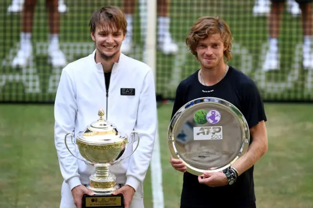 Alexander Bublik holds the Halle Open champion's trophy and Andrey Rublev holds the Halle Open runner-up trophy