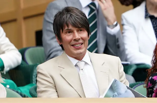 Brian Cox sits in the royal box on Centre Court